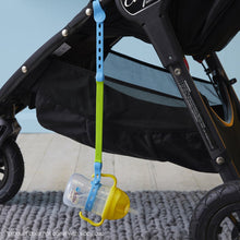 a b.box lemon sippy cup attached to a b.box ocean breeze connect a cup hanging on the side of a stroller pram push chair