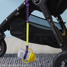 a b.box lemon sippy cup attached to a b.box passion splash connect a cup hanging on the side of a stroller pram push chair