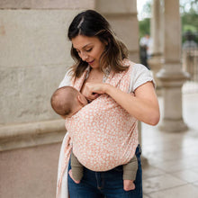 a mum breastfeeding the baby while still wrapped up