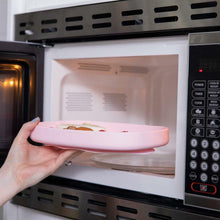 tray with food being put in a microwave
