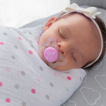 newborn swaddles and sleep with a micro soother in its mouth, clear with pink circles saying little princess 