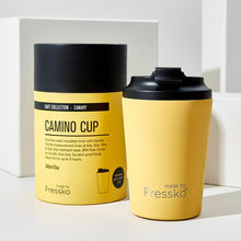 bright yellow cup with black lid and packing in the same colour