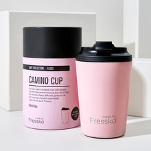 pale pink cup with black lid and packing in the same colour