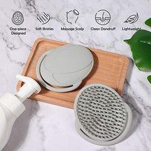 pump bottle, wooden chopping board and two silicone brushes - one with the back up and the other with the spikes up on a white marble background