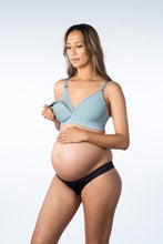Person wearing bra while pregnant showing the bra feeding option