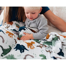 Close up of an adult and child under a quilt 