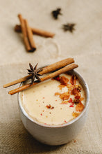 pottery mug filled with fresh cardamom and star anise on top