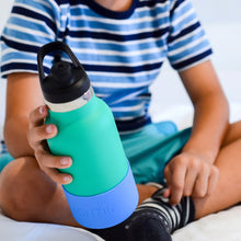 a young child holding a mini green drink bottle with a blueberry mid blue bumper