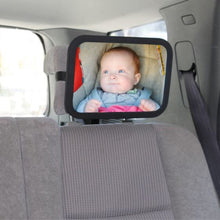 vehicle back seat with mirror installed on the head rest and a view of a baby in their car seat